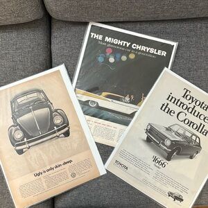 3 Vintage poster advertisements for Volkswagen, Chrysler, and Toyota
